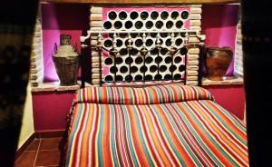 a couch in a room with a wine rack at Cueva La Ermita in Guadix
