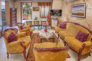 a living room with two couches and a table at Port Inn in Haifa