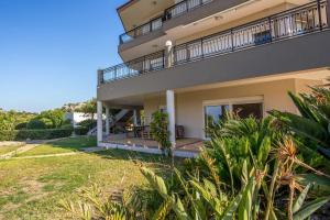 a view of a house with a yard at AGGELOS GARDEN VIEW in Faliraki