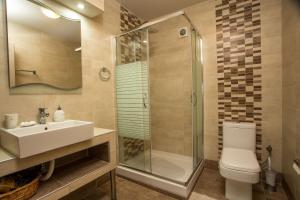a bathroom with a toilet and a sink and a shower at AGGELOS GARDEN VIEW in Faliraki