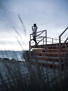 a person taking a picture of the water with a camera at Titilaka - Relais & Châteaux in Tililaca