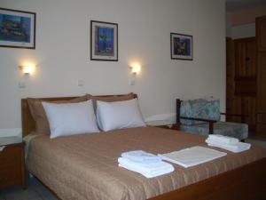 a bedroom with a bed with towels on it at Villa Ira Studios - Apartments in Parga