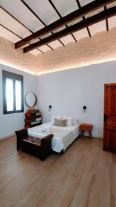 a bedroom with a large bed and a wooden floor at Miraflores 58 Apt - Private Parking Opt in Seville