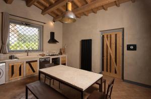 a kitchen with a table and a sink and a window at BED&BEER BIRRIFICIO LA GRAMIGNA in Perugia