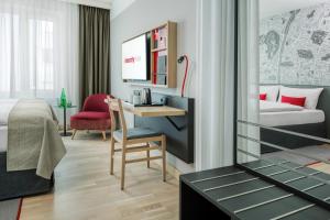 ein Hotelzimmer mit einem Bett und einem Schreibtisch in der Unterkunft IntercityHotel Graz in Graz