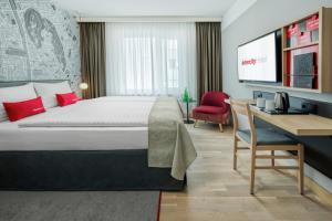 a hotel room with a bed and a desk at IntercityHotel Graz in Graz