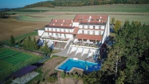 an aerial view of a house with a tennis court at Hotel Berounka in Hřebečníky