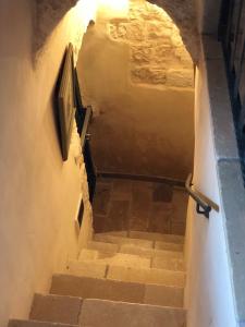 a set of stairs in a cave with a television at Casa Federico in Ostuni