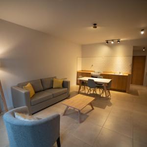 a living room with a couch and a table at BOG Norway - Departamentos Céntricos in Villa La Angostura