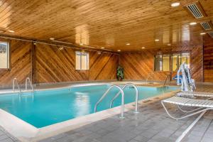 a swimming pool with a wooden ceiling at Quality Inn Bloomington Near University in Bloomington