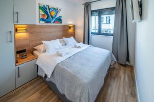 Posteľ alebo postele v izbe v ubytovaní PINNA RESIDENCE - PINNA