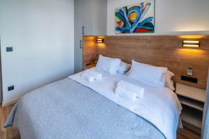 Posteľ alebo postele v izbe v ubytovaní PINNA RESIDENCE - PINNA