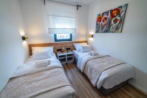 Posteľ alebo postele v izbe v ubytovaní PINNA RESIDENCE - PINNA