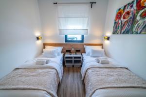 Posteľ alebo postele v izbe v ubytovaní PINNA RESIDENCE - PINNA