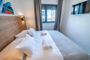 Posteľ alebo postele v izbe v ubytovaní PINNA RESIDENCE - PINNA