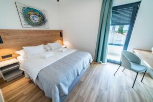 Posteľ alebo postele v izbe v ubytovaní PINNA RESIDENCE - PINNA