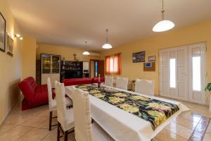 a kitchen and dining room with a table and chairs at Sonja Vacation home in Podorjak