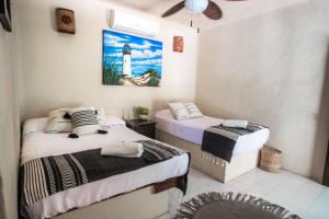 Postel nebo postele na pokoji v ubytování Hotel Macondo Holbox