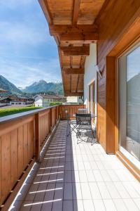 a balcony with chairs and a view of the mountains at 5-star Chalet Helen Deluxe in Kaprun with Air Condition in Kaprun