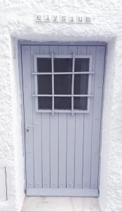 a garage door with a window in a white building at Elysium - a romantic escape in Mojacar Pueblo in Mojácar