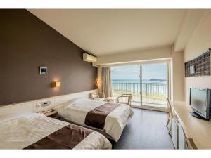 a hotel room with two beds and a large window at HOTEL GranView Garden OKINAWA - Vacation STAY 44964v in Tomigusuku