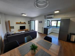 a living room with a couch and a table at Hiša Špuntar in Bovec