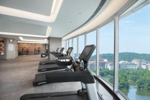 ein Fitnessstudio mit einer Reihe von Laufbändern und Crosstrainern in der Unterkunft Crowne Plaza Wuhan Optics Valley, an IHG Hotel in Wuhan