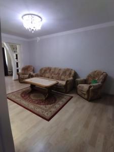 a living room with two couches and a coffee table at Apartment for you in Tbilisi City