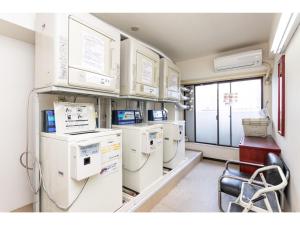 a hospital room with machines and a chair in it at Sky Heart Hotel Koiwa - Vacation STAY 49106v in Tokyo