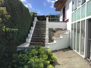 a stairway leading up to a white house at Ferienhaus Grabowblick in Barth