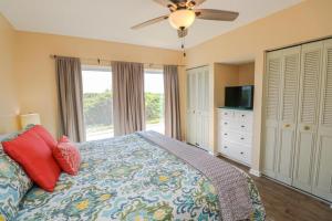 a bedroom with a bed and a ceiling fan at Creston House 12B in St. Augustine