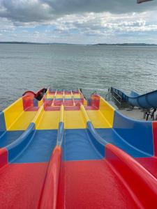 a inflatable water slide on a boat in the water at Pelso Camping in Alsóörs