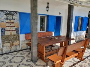 a table and chairs in a room with blue windows at Sea House Bassi in Kraljevica