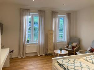 摩泽尔河畔的泽尔Apartment Hallenbach的卧室配有床、桌子和窗户。