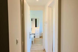 a hallway leading to a room with a mirror at PROVENCE APPARTEMENT in Manosque +29 photos