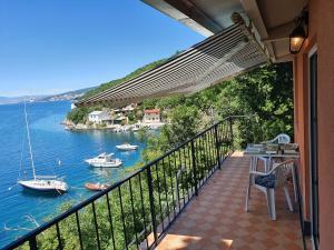 a balcony with a view of the water and boats at Sea House Bassi in Kraljevica