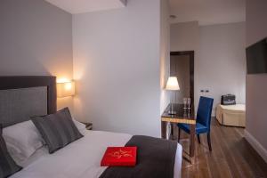 Posteľ alebo postele v izbe v ubytovaní Tridente Suites