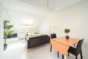 a living room with a table and a couch at Beautiful Terrace Apartment in the Heart of Antwerp in Antwerp +3 photos