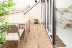 a balcony with a table and chairs on a building at Beautiful Terrace Apartment in the Heart of Antwerp in Antwerp