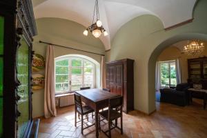 a dining room with a wooden table in a room at La loggia dei frati in Cannero Riviera