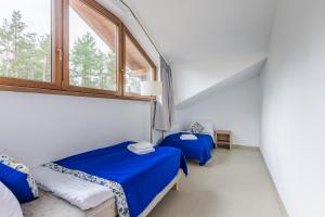 Ένα ή περισσότερα κρεβάτια σε δωμάτιο στο Źródło Raduni