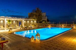 a swimming pool in a resort at night at Sigal Villa in Akrotiri +51 photos