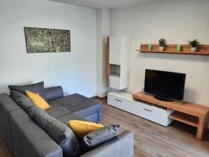 a living room with a couch and a flat screen tv at Hiša Špuntar in Bovec
