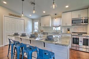 a kitchen with a large island with blue stools at Pet-Friendly Ocean City Home Half Mile to Beach! in Ocean City