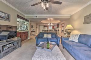 a living room with blue couches and a tv at Waterfall/6th‑Floor View/Walk Downtown in Gatlinburg +28 photos
