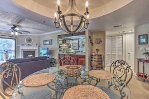 a living room with a glass table and chairs at Waterfall/6th‑Floor View/Walk Downtown in Gatlinburg