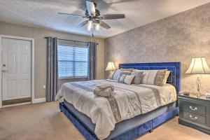 a bedroom with a blue bed and a ceiling fan at Waterfall/6th‑Floor View/Walk Downtown in Gatlinburg