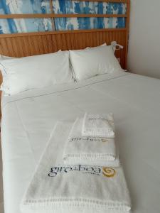 a bed with two towels and two pillows on it at B&B Giro Di Boa in Lampedusa