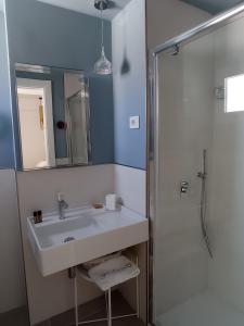 a bathroom with a sink and a shower at B&B Giro Di Boa in Lampedusa