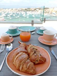 a plate of bread and croissants on a table at B&B Giro Di Boa in Lampedusa